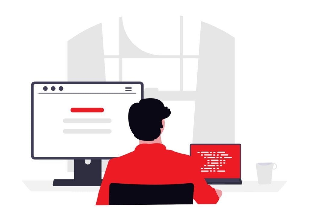 An illustration of a person in a red shirt sitting at a desk, working on a large computer monitor and a small red laptop that shows code.